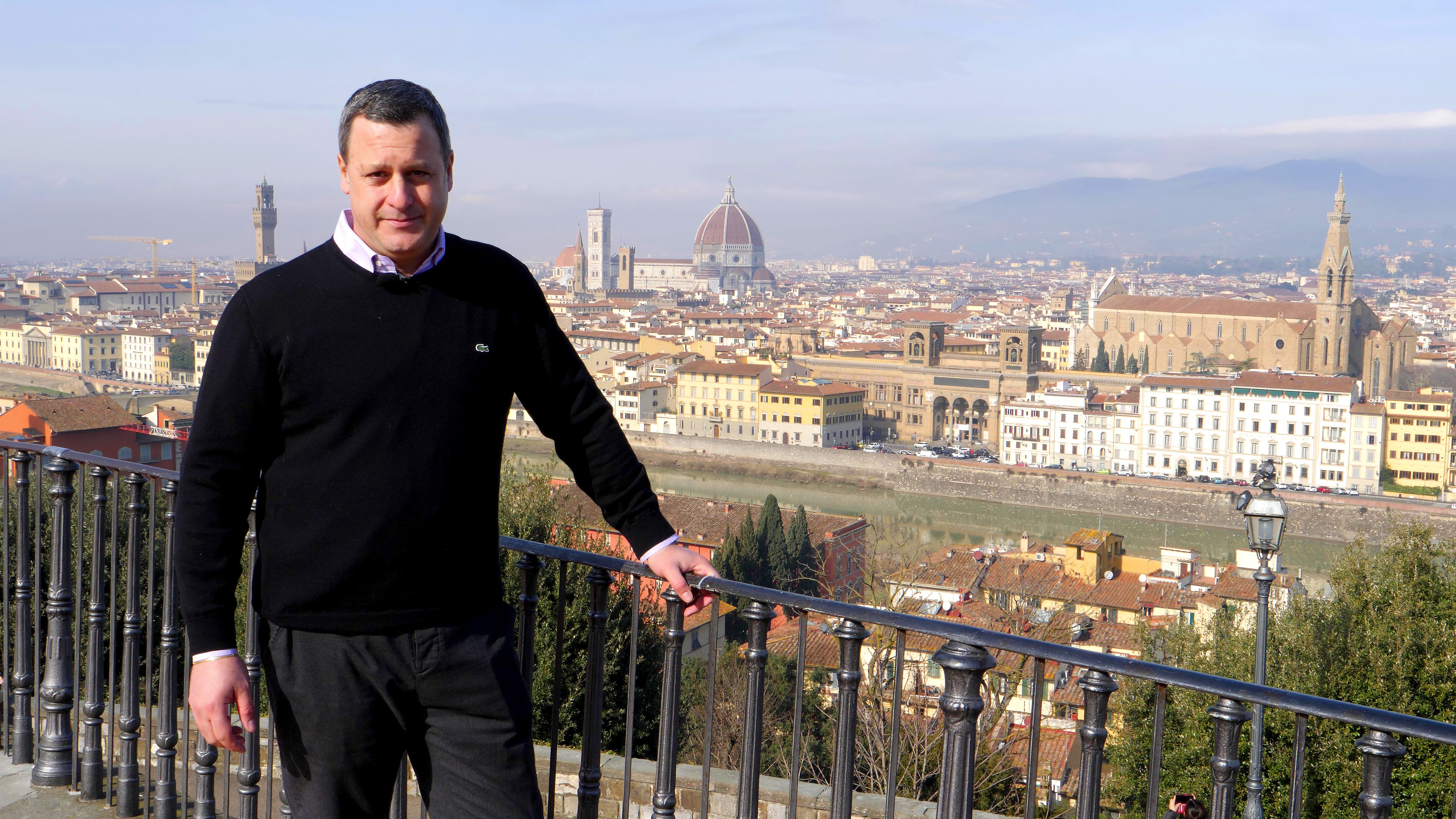 Dr. Rocky Ruggiero stands at the Piazzale Michelangelo to give an overview of the historic buildings that make up the iconic skyline of Florence, Italy.